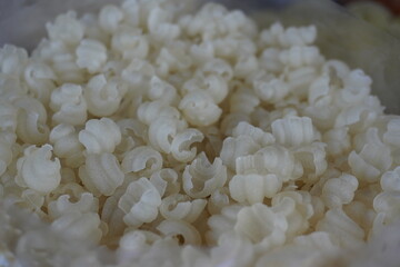 Uncooked fryums, a popular Indian snack which are made from various ingredients and are known for their unique shapes and textures when fried