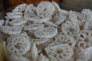 A uncooked raw cracker a popular snacks in India are displayed in a market setting likely for sale