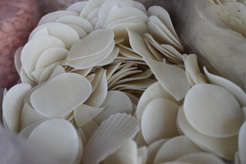 Uncooked prawn crackers, a traditional snack popular in Southeast Asia which are typically made from a mixture of ground shrimp, tapioca flour, and seasonings