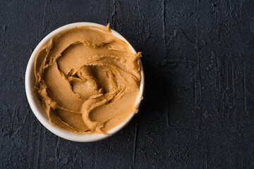  Delicious and healthy peanut butter on black background