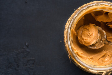  Delicious and healthy peanut butter on black background