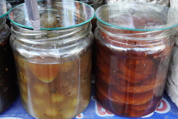 Homemade or locally produced preserves likely amla jam and fig jam in the glass jars