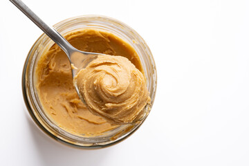 Delicious and healthy peanut butter on white background