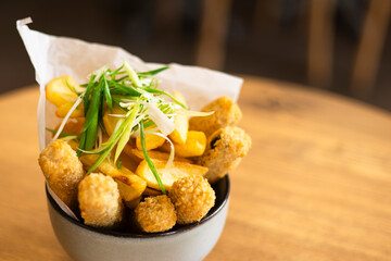 Tofu sticks and deep fried potatoes, vegan snack concept. Copy space.