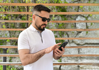 A businessman looking at his phone, ready to make a call.A man engaged in a business conversation...