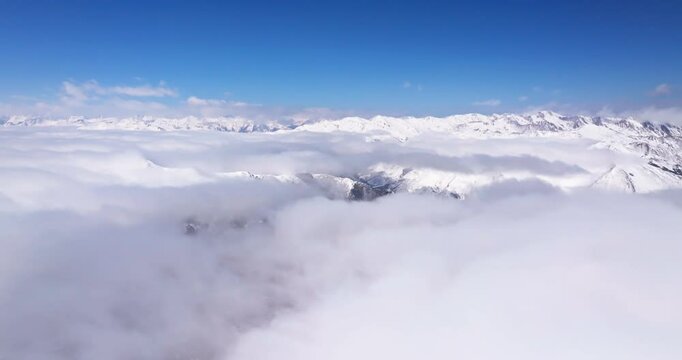 aerial view timelapse of winter snow mountain landscape with clouds mist moving