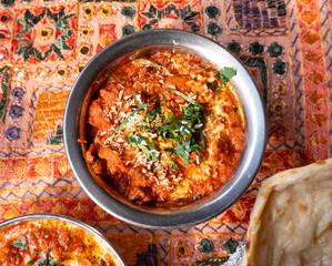 Lamb curry with tomatoes and fiery chili, traditional Indian Laal Maas served in a metal dish