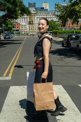 Stylish goth woman crossing the street after shopping in buenos aires
