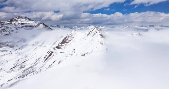 Aerial time lapse of Snow mountain of Jiajinshan in Sichuan China with clouds and mist, amazing nature landscape