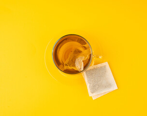 Herbal tea sachet in cup, hot water with chamomile and Hypericum or St. John's wort teabag