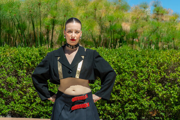 Stylish fashion model posing in botanical garden setting