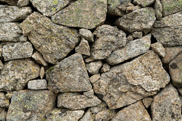 Granite stone wall, old construction. Concept: Construction, stone, wall, stone wall.