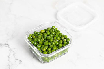 green peas in glass container for storage and cooking, healthy lifestyle, vegetable protein, potassium, fiber