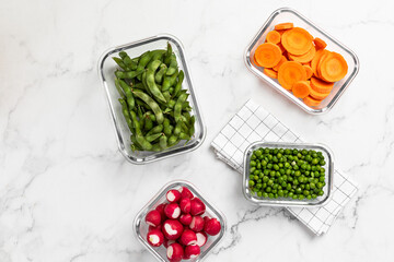 vegetables in glass containers for storage, healthy lifestyle, carrots, peas, radishes