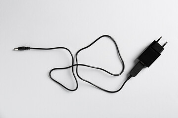 USB power adapter with charge cable on white background, top view