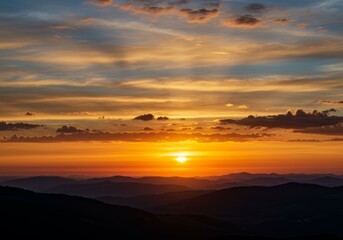 Fototapeta premium Mountain Range at Colorful Sunset with Dramatic Sky and Rolling Hills