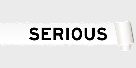 Ripped gray paper background that have word serious under torn part