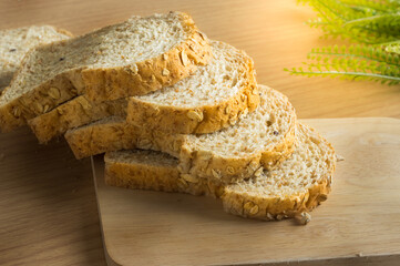 Sliced whole wheat breads with cutting board.