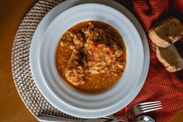 homemade recipe of orange lentils with chicken on home stage