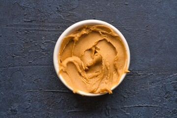  Delicious and healthy peanut butter on black background