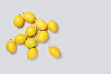 group nine lemons different sizes light grey background top down