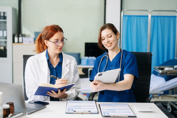 Fototapeta premium Doctors and nurses collaborating in a modern medical office, showcasing teamwork and patient care.