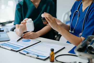 Doctors and nurses collaborate on medical treatment and prescription plans, analyzing data