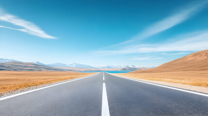 Naklejka premium Long straight road stretching through a vast desert landscape under a blue sky. This scenic highway is perfect for travel photography, road trip blogs, and adventure themes. Selective focus