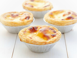Egg Tart on white wooden background.