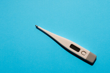 pharmacy medicament white electronic thermometer on blue background