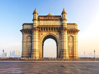 A large arched sandstone monument stands tall under a clear sky