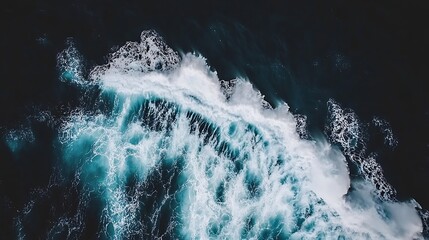 Aerial view depicts powerful waves crashing upon dark ocean water