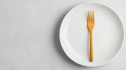 Close-up of a white plate and fork in minimalist style. White plate with a matte yellow fork in retro style.