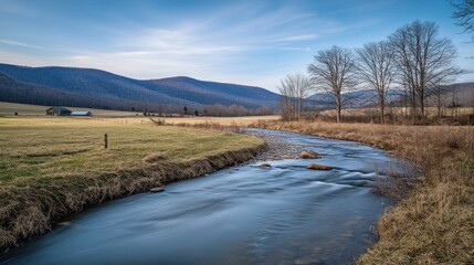 A flowing river winds through a rural countryside landscape in daylight