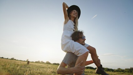 A Joyful Couple Enthusiastically Embracing Life in a Beautiful Sunlit Open Field