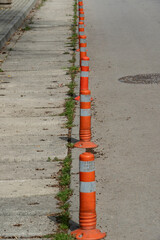 Old orange traffic signs on a dirty asphalt road