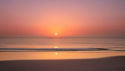 Obraz premium Tranquil minimalist beach sunset scene as the sun dips below the horizon, leaving behind a soft, beautiful gradient of orange and pink in the sky
