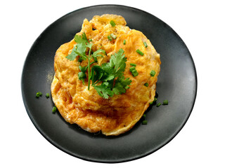 Omelet on black plate isolated on white background.