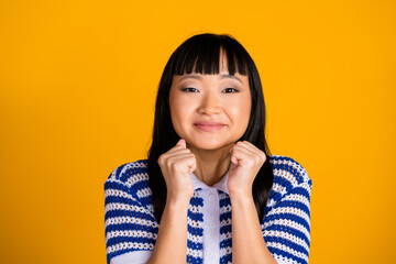 Young Asian Woman in Striped Polo Smiling Cheerfully, Expressing Joy and Excitement Over Vibrant...