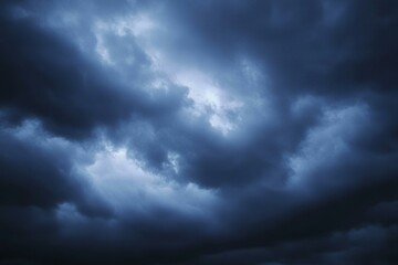 Obraz premium Black dark blue gray sky with heavy clouds. Dramatic background. Storm hurricane wind rain cloudy. Ominous scary creepy.