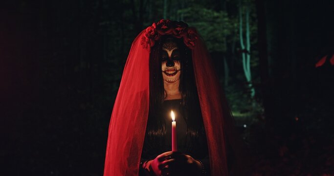 A Mystical Figure Stands in a Dark Forest, Clutching a Candle, With a Dramatic Veil Flowing Behind