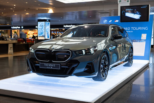 07.03.2025 , Munich International Airport, Germany. 2025 BMW i5 G60 generation electric 5 series touring displayed on an airport terminal stand. Front side view, no people