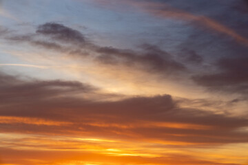 Vibrant sunrise sky with blue and orange clouds