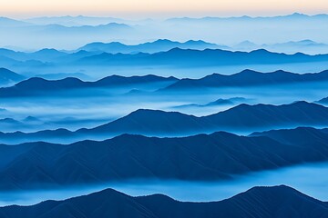Blue mountain ranges blanketed by low lying atmospheric clouds and fog