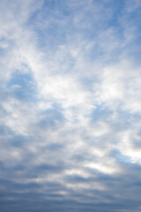 soft blue sky with textured clouds at dawn  