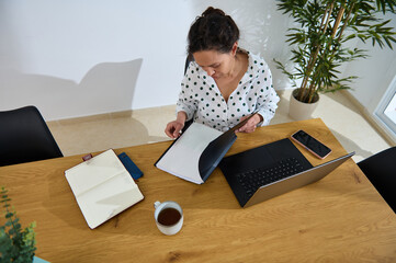 Young Woman Working Remotely on a Project at Home Office Desk