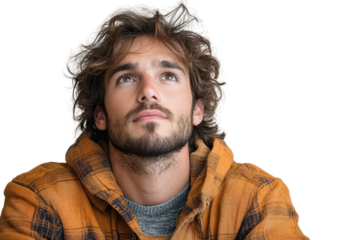 A thoughtful young man with a beard and long hair gazes upwards, reflecting on life while wearing an orange checkered hoodie.