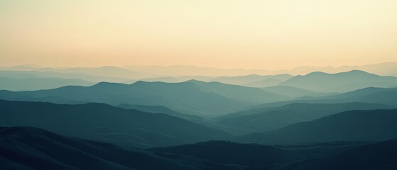 Obraz premium Layered mountain ranges stretch into the distance under a soft, pastel sky, creating a peaceful and infinite vista.