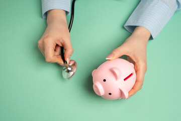 Medical examination of a piggy bank with a stethoscope. Concept of savings and financial health....