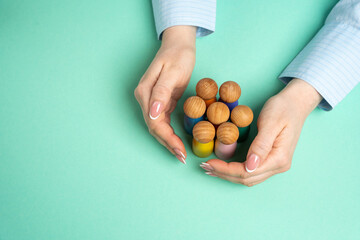 Hands protect a group of human figures. Social protection concept. Community support, and...